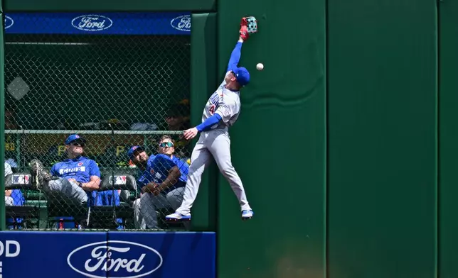 Chicago Cubs center fielder Pete Crow-Armstrong leaps in an unsuccessful attempt to catch a ball hit by Pittsburgh Pirates' Brandon Lowe during the third inning of a baseball game, Monday, May 25, 2026, in Pittsburgh. (AP Photo/David Dermer)