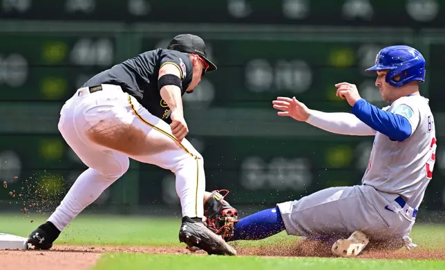 Pittsburgh Pirates shortstop Konnor Griffin tags out Chicago Cubs' Alex Bregman at second base on a steal attempt during the fifth inning of a baseball game, Monday, May 25, 2026, in Pittsburgh. (AP Photo/David Dermer)