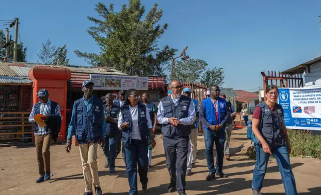 Director General of the World Health Organisation (WHO) Tedros Adhanom Ghebreyesus, center right, visits the Evangelical Medical Center (CEM) in Bunia, Congo, Sunday, May 31, 2026. (AP Photo/Moses Sawasawa)
