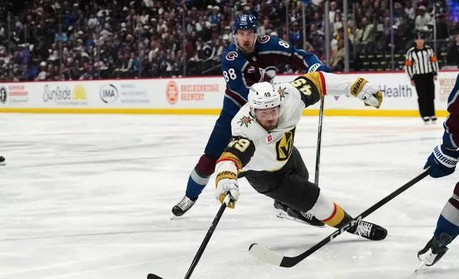 Vegas Golden Knights left wing Ivan Barbashev, front, falls after being tripped by Colorado Avalanche center Martin Necas (88) during the second period in Game 2 of the Western Conference finals NHL hockey Stanley Cup playoff series Friday, May 22, 2026, in Denver. (AP Photo/David Zalubowski)