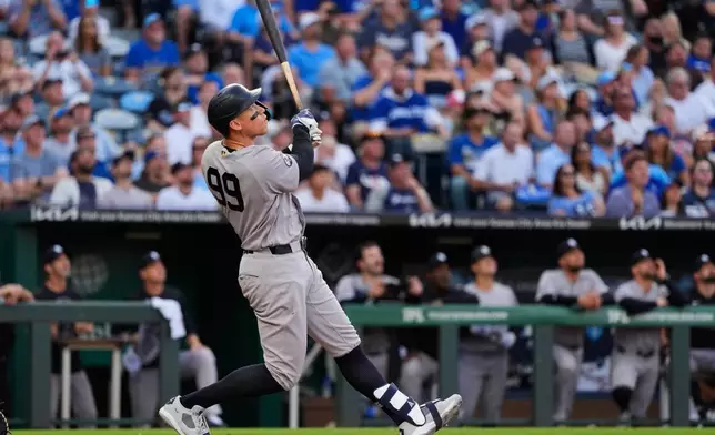 New York Yankees' Aaron Judge watches his sacrifice fly to score a run during the fourth inning of baseball game against the Kansas City Royals, Wednesday, May 27, 2026, in Kansas City, Mo. (AP Photo/Charlie Riedel)
