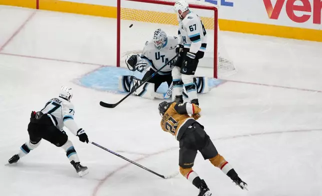 Vegas Golden Knights center Brett Howden (21) scores on Utah Mammoth goaltender Karel Vejmelka (70) in the second overtime of Game 5 of a first-round NHL hockey Stanley Cup playoff series Wednesday, April 29, 2026, in Las Vegas. (AP Photo/John Locher)