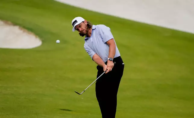 Tommy Fleetwood, of England, chips onto the 15th green during second round of the Truist Championship golf tournament at the Quail Hollow Club, Friday, May 8, 2026, in Charlotte, N.C. (AP Photo/Chris Carlson)