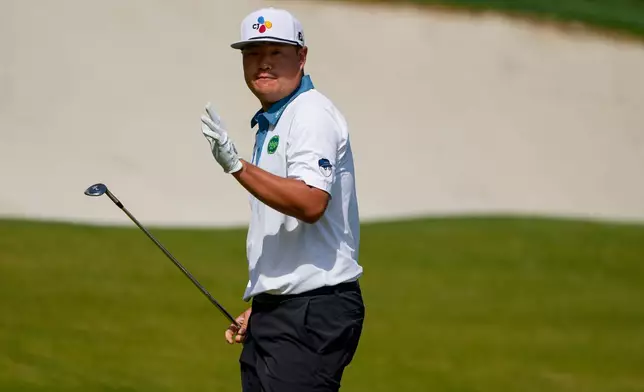 Sungjae Im, of South Korea, acknowledges the gallery on the 15th green during second round of the Truist Championship golf tournament at the Quail Hollow Club, Friday, May 8, 2026, in Charlotte, N.C. (AP Photo/Chris Carlson)
