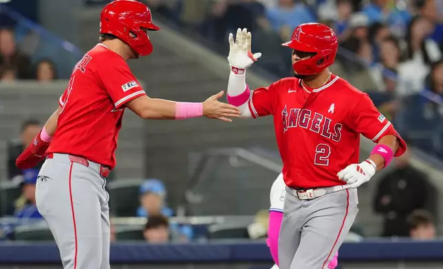 Los Angeles Angels' Nolan Schanuel, left, congratulates Oswald Peraza (2) after Peraza hit a two-run home run during the top of the fifth inning of a baseball game against the Toronto Blue Jays in Toronto, Sunday, May 10, 2026. (Frank Gunn/The Canadian Press via AP)