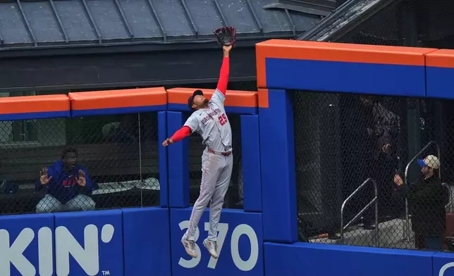 Washington Nationals' James Wood makes a leaping catch at the wall on a ball hit by New York Mets' Juan Soto during the first inning of a baseball game Thursday, April 30, 2026, in New York. (AP Photo/Frank Franklin II)