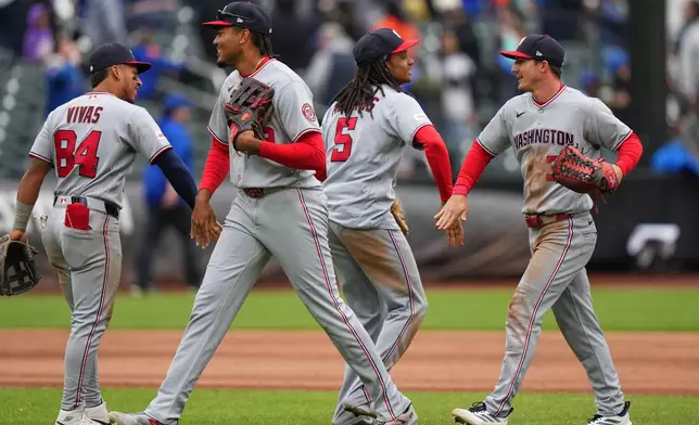 Washington Nationals' Jorbit Vivas (84) and CJ Abrams (5) celebrates with James Wood and Jacob Young after a baseball game against the New York Mets Thursday, April 30, 2026, in New York. (AP Photo/Frank Franklin II)