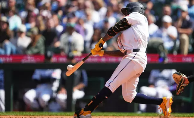 Seattle Mariners' Randy Arozarena hits a two-run home run against the Chicago White Sox during the seventh inning of a baseball game, Wednesday, May 20, 2026, in Seattle. (AP Photo/Lindsey Wasson)