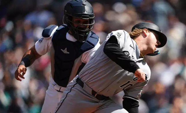 Chicago White Sox's Chase Meidroth is tagged out stealing home by Seattle Mariners catcher Jhonny Pereda during the sixth inning of a baseball game, Wednesday, May 20, 2026, in Seattle. (AP Photo/Lindsey Wasson)