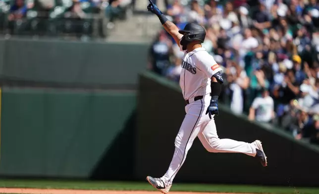 Seattle Mariners' Jhonny Pereda jogs the bases after hitting a solo home run against the Chicago White Sox during the seventh inning of a baseball game, Wednesday, May 20, 2026, in Seattle. (AP Photo/Lindsey Wasson)