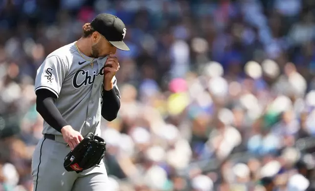 Chicago White Sox starting pitcher Sean Burke walks back to the dugout after the fourth inning of a baseball game against the Seattle Mariners, Wednesday, May 20, 2026, in Seattle. (AP Photo/Lindsey Wasson)