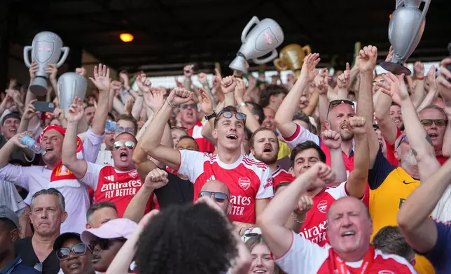 Arsenal supporters celebrate after the English Premier League soccer match between Crystal Palace and Arsenal in London, England, Sunday, May 24, 2026. (AP Photo/Kin Cheung)