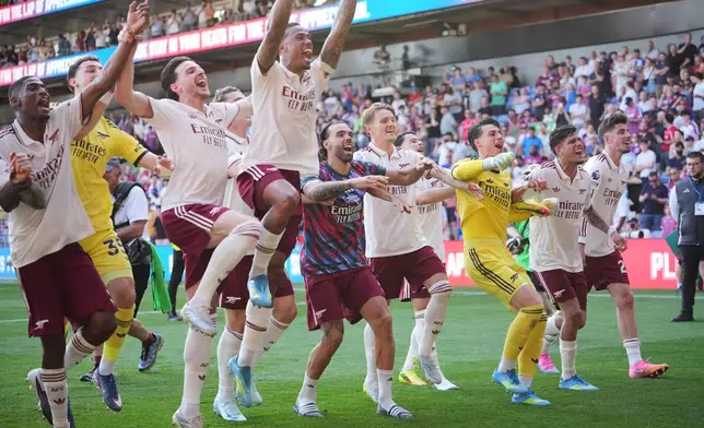 Arsenal players celebrate after the English Premier League soccer match between Crystal Palace and Arsenal in London, England, Sunday, May 24, 2026. (AP Photo/Kin Cheung)