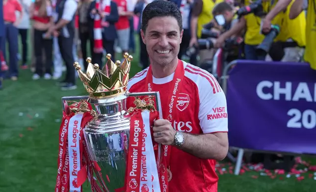Arsenal's manager Mikel Arteta holds the trophy during celebrating their Premier League title after the English Premier League soccer match between Crystal Palace and Arsenal in London, England, Sunday, May 24, 2026. (AP Photo/Kin Cheung)