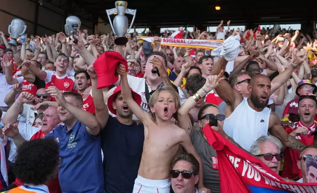 Arsenal supporters celebrate after the English Premier League soccer match between Crystal Palace and Arsenal in London, England, Sunday, May 24, 2026. (AP Photo/Kin Cheung)