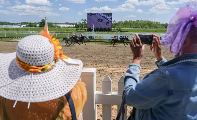Sharon Jelani and Jacquelyne Barnes, both of Baltimore, watch Preakness Meet horse racing at Laurel Park, Friday, May 8, 2026, in Laurel, Md. (AP Photo/Julia Demaree Nikhinson)