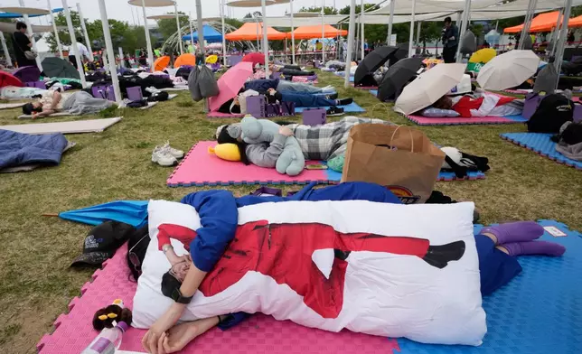 Participants take a nap during the 2026 Hangang Nap Competition at Yeouido Hangang Park in Seoul, South Korea, Saturday, May 2, 2026. (AP Photo/Ahn Young-joon)
