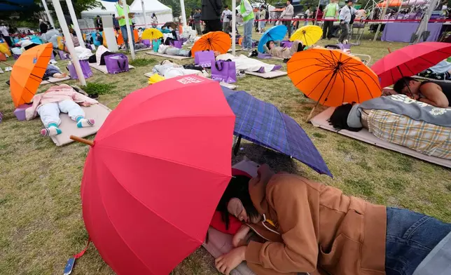 Participants take a nap during the 2026 Hangang Nap Competition at Yeouido Hangang Park in Seoul, South Korea, Saturday, May 2, 2026. (AP Photo/Ahn Young-joon)