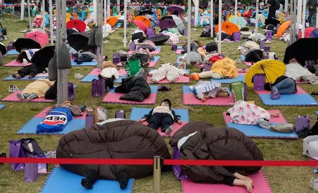 Participants take a nap during the 2026 Hangang Nap Competition at Yeouido Hangang Park in Seoul, South Korea, Saturday, May 2, 2026. (AP Photo/Ahn Young-joon)