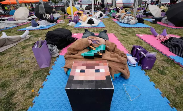 A participant takes a nap during the 2026 Hangang Nap Competition at Yeouido Hangang Park in Seoul, South Korea, Saturday, May 2, 2026. (AP Photo/Ahn Young-joon)