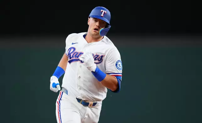 Texas Rangers' Josh Jung runs the bases after hitting a solo home run against the Chicago Cubs during the second inning of a baseball game Saturday, May 9, 2026, in Arlington, Texas. (AP Photo/Julio Cortez)