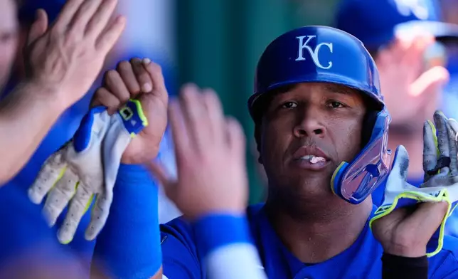 Kansas City Royals' Salvador Perez celebrates in the dugout after scoring on a sacrifice fly hit by Michael Massey during the second inning of baseball game against the New York Yankees, Monday, May 25, 2026, in Kansas City, Mo. (AP Photo/Charlie Riedel)