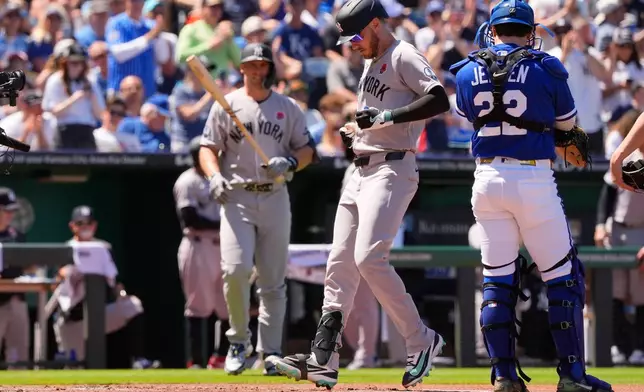 New York Yankees left fielder Cody Bellinger, center, runs home to score after hitting a solo home run during the second inning of baseball game against the Kansas City Royals, Monday, May 25, 2026, in Kansas City, Mo. (AP Photo/Charlie Riedel)