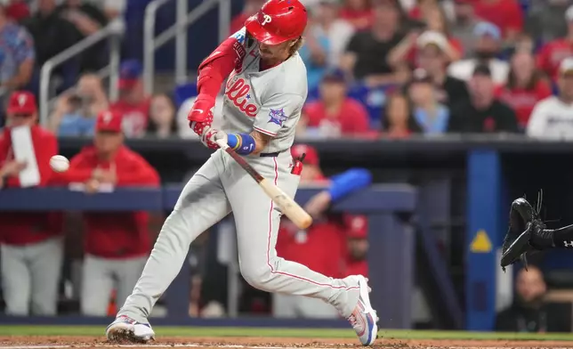 Philadelphia Phillies' Bryson Stott hits a three-run home run in the first inning of a baseball game against the Miami Marlins, Sunday, May 3, 2026, in Miami. (AP Photo/Jim Rassol)