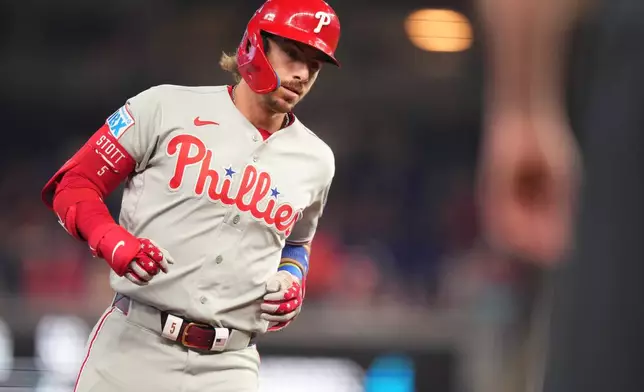 Philadelphia Phillies' Bryson Stott rounds third base after hitting a three-run home run against the Miami Marlins in the first inning of a baseball game, Sunday, May 3, 2026, in Miami. (AP Photo/Jim Rassol)