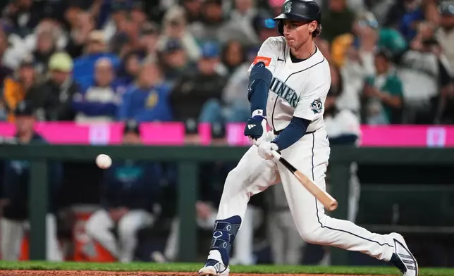 Seattle Mariners' Colt Emerson hits a three-run home run, the first major league hit of his career, against the Chicago White Sox during the eighth inning of a baseball game, Monday, May 18, 2026, in Seattle. (AP Photo/Lindsey Wasson)