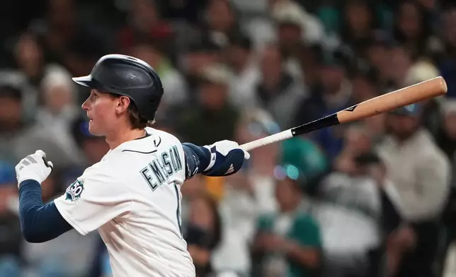 Seattle Mariners' Colt Emerson follows through on a three-run home run against the Chicago White Sox during the eighth inning of a baseball game, Monday, May 18, 2026, in Seattle. (AP Photo/Lindsey Wasson)