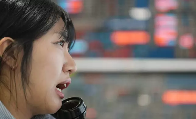 A dealer talks on the phone at a dealing room of Hana Bank in Seoul, South Korea, Wednesday, May 6, 2026. (AP Photo/Lee Jin-man)