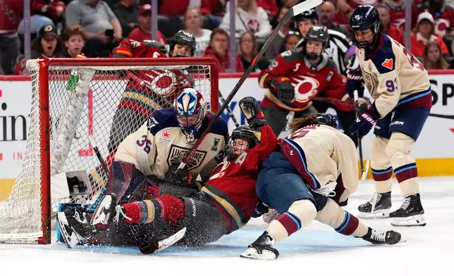 Ottawa Charge's Jocelyne Larocque (3) falls in the crease of Montreal Victoire goaltender Ann-Renee Desbiens (35) after chasing the puck during the second period of game 4 PWHL Walter Cup final hockey game in Ottawa, Wednesday, May 20, 2026. (Adrian Wyld/The Canadian Press via AP)