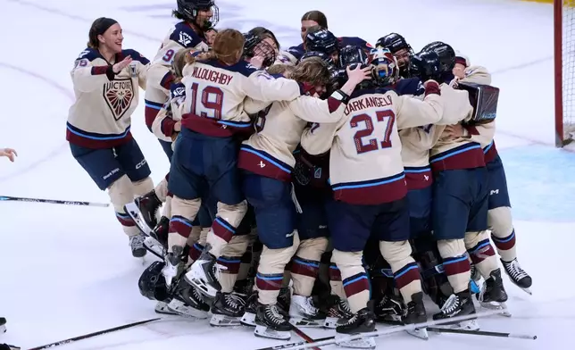 Montreal Victoire players celebrate after defeating the Ottawa Charge to win the PWHL Walter Cup hockey final in Ottawa, Wednesday May 20, 2026. (Adrian Wyld/The Canadian Press via AP)