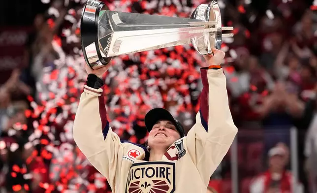 Montreal Victoire's Marie-Philip Poulin (29) raises the PWHL Walter Cup after the team's win against the Ottawa Charge, in Ottawa, on Wednesday, May 20, 2026. (Adrian Wyld/The Canadian Press via AP)