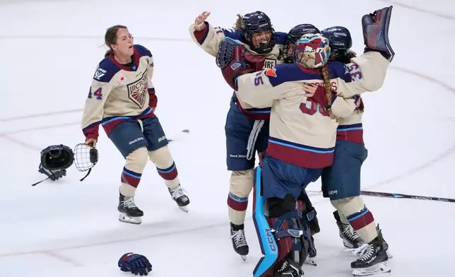 Montreal Victoire players celebrate after defeating the Ottawa Charge to win the PWHL Walter Cup hockey final in Ottawa, Wednesday May 20, 2026. (Adrian Wyld/The Canadian Press via AP)