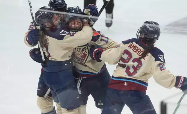 Montreal Victoire forward Abby Roque (11) celebrates her goal against the Ottawa Charge with teammates during the third period of game 4 PWHL Walter Cup final hockey game in Ottawa, Wednesday, May 20, 2026. (Adrian Wyld/The Canadian Press via AP)
