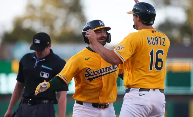 Athletics' Shea Langeliers, second from right, celebrates with teammate Nick Kurtz (16) after hitting a two-run home run during the first inning of a baseball game against the New York Yankees, Saturday, May 30, 2026, in West Sacramento, Calif. (AP Photo/Scott Marshall)