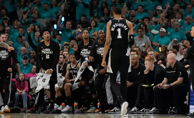 San Antonio Spurs forward Victor Wembanyama (1) walks toward the bench during the second half of Game 3 in the Western Conference finals NBA basketball playoffs series against the Oklahoma City Thunder Friday, May 22, 2026, in San Antonio. (AP Photo/Ashley Landis)