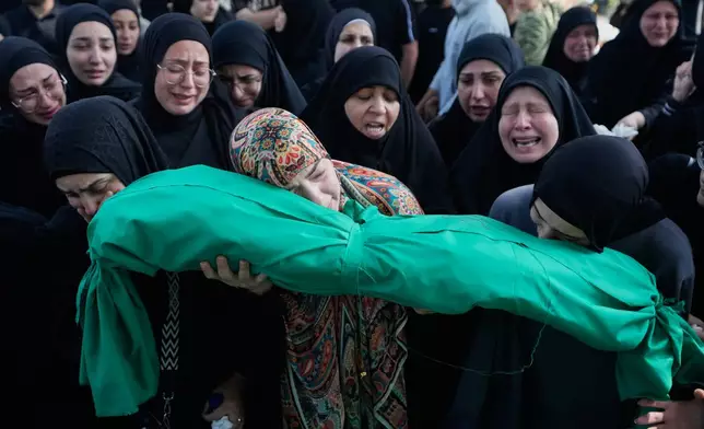 Women grieve as they carry the body of 6-month-old Mariam Fahos during a funeral procession for people killed a day earlier in an Israeli airstrike in the village of Saksakieh, in the southern port city of Sidon, Lebanon, Sunday, May 10, 2026. (AP Photo/Mohammed Zaatari)