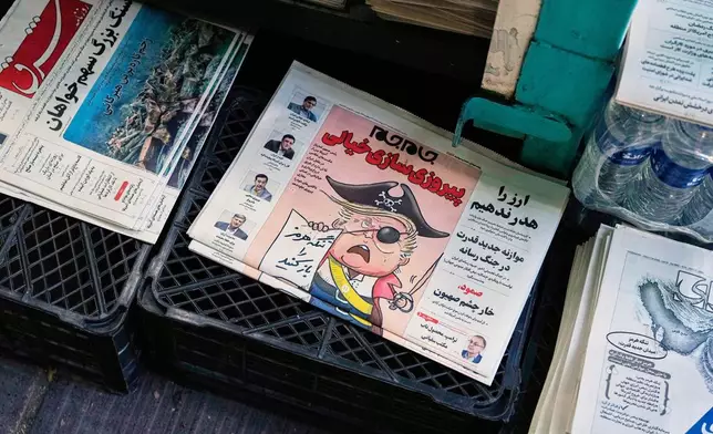 The front page of the Sunday May 10, 2026, edition of Iranian newspaper, Jamejam, is seen with a cartoon satirizing the U.S. President Donald Trump that asks: "Open the the Strait of Hormuz" on a news stand in northern Tehran, Iran, Sunday, May 10, 2026. (AP Photo/Vahid Salemi)