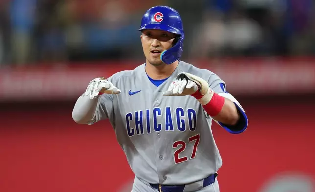 Chicago Cubs' Seiya Suzuki gestures while running the bases after hitting a two-run home run off Texas Rangers starting pitcher Kumar Rocker during the fourth inning of a baseball game Friday, May 8, 2026, in Arlington, Texas. (AP Photo/Julio Cortez)
