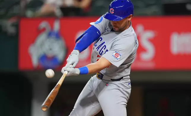 Chicago Cubs designated hitter Michael Conforto connects for a double off Texas Rangers starting pitcher Kumar Rocker during the first inning of a baseball game Friday, May 8, 2026, in Arlington, Texas. (AP Photo/Julio Cortez)