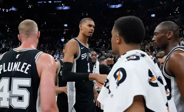 San Antonio Spurs forward Victor Wembanyama (1) speaks to reammates after a win over the Oklahoma City Thunder after Game 6 in the Western Conference finals NBA basketball playoffs series, Thursday, May 28, 2026, in San Antonio. (AP Photo/David J. Phillip)