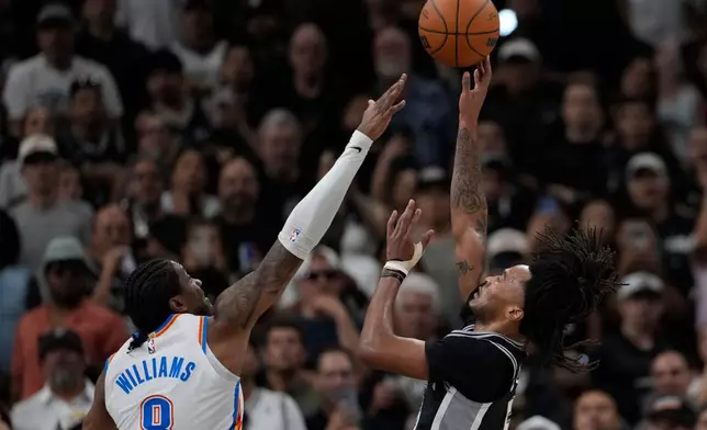 San Antonio Spurs guard Stephon Castle (5) shoots over Oklahoma City Thunder guard Jalen Williams (8) in the second half of Game 6 in the Western Conference finals NBA basketball playoffs series, Thursday, May 28, 2026, in San Antonio. (AP Photo/David J. Phillip)