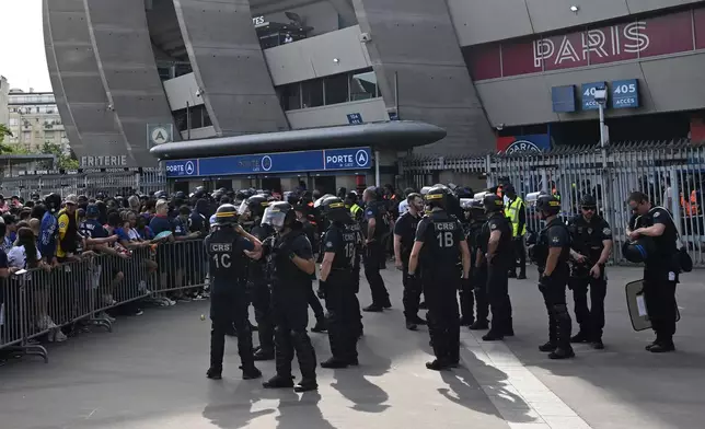 PSG supporters gather outside their stadium in Paris, Saturday, May 30, 2026 to watch the Champions League final soccer match between Paris Saint-Germain and Arsenal that's being played in Budapest. (AP Photo/Emma Da Silva)