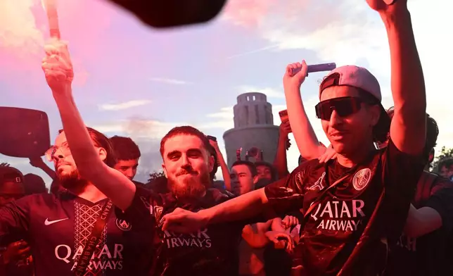 PSG supporters celebrate in Paris, Saturday, May 30, 2026 after the Champions League final soccer match between Paris Saint-Germain and Arsenal that's being played in Budapest, PSG won the match. (AP Photo/Emma Da Silva)