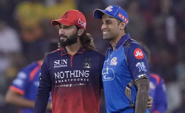 Royal Challengers Bengaluru's captain Rajat Patidar, left, and Mumbai Indians' captain Suryakumar Yadav stands before toss during the Indian Premier League cricket match between Royal Challengers Bengaluru and Mumbai Indians in Raipur, India, Sunday, May 10, 2026. (AP Photo/Mahesh Kumar A.)