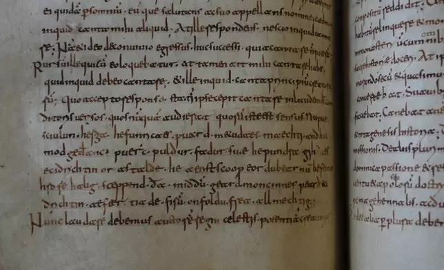 A rare, long-lost copy of Caedmon's Hymn — the first poem ever written down in Old English — is visible in the five lines above the final line of a page from an 8th-century manuscript copy of the Venerable Bede's Ecclesiastical History of the English People, at Rome's National Library, Thursday, May 8, 2026. (AP Photo/Andrea Rosa)