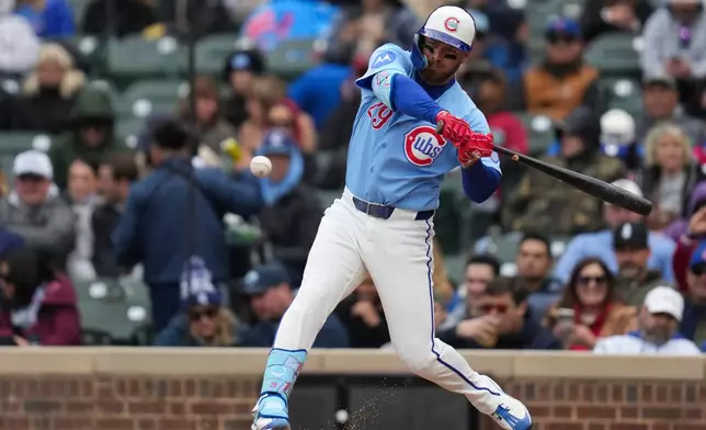 Chicago Cubs' Michael Busch (29) hits a two-run single during the first inning of a baseball game against the Arizona Diamondbacks, Friday, May 1, 2026, in Chicago. (AP Photo/Erin Hooley)